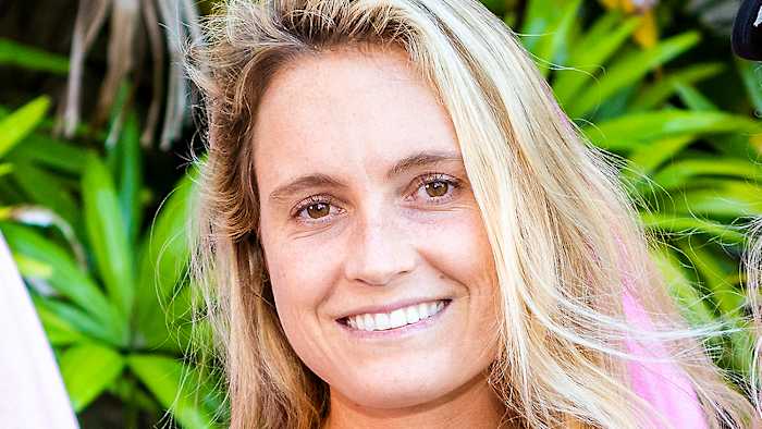 Alana Blanchard poses with her blonde hair down in a relaxed wave and smiles for the camera.